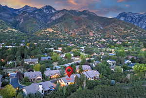 Aerial overview of property's location featuring a mountainous background and nearby suburban area