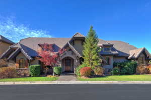 Tudor home with stone siding, stucco siding, and a tiled roof