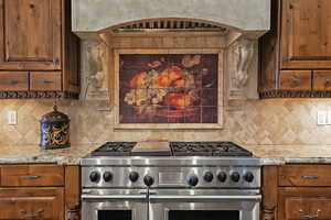 Kitchen with exhaust hood, double oven range, and brown cabinets