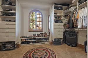 Walk in closet featuring light colored carpet