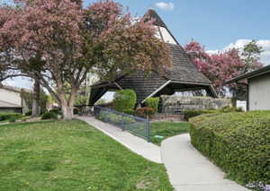 View of property's community featuring a lawn