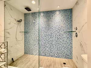 Full bathroom featuring a walk in shower, recessed lighting, and wood tiled floors