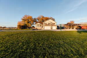 View of front facade featuring a front lawn and concrete driveway