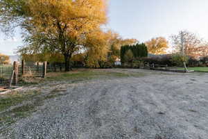 View of dirt / gravel road featuring a view of rural / pastoral area