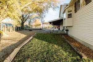 Fenced backyard featuring a playground and a porch