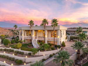 View of front facade featuring stairway, concrete driveway, a fenced front yard, and stucco siding