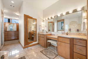 Bathroom with two vanities, a stall shower, light tile patterned floors, and recessed lighting