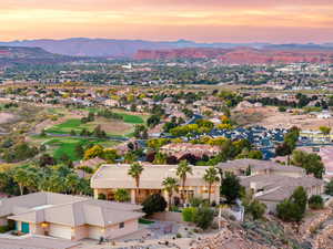 Aerial perspective of suburban area with a mountain backdrop and a local golf course