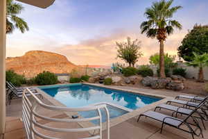 View of pool with a fenced backyard, a patio area, and a mountain view