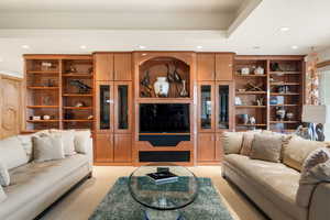 Living area with recessed lighting and light colored carpet