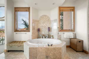 Bathroom featuring a tub with jets and tile patterned floors