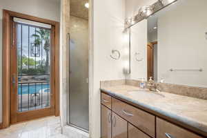 Bathroom featuring vanity and a shower stall