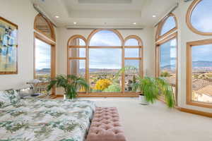 Bedroom with a mountain view, a raised ceiling, carpet floors, and recessed lighting