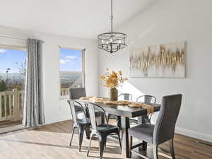 Dining space featuring wood finished floors and a chandelier