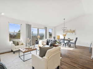 Living area with wood finished floors, high vaulted ceiling, and million dollar view