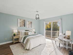 Master Bedroom with access to outside and wood finished floors