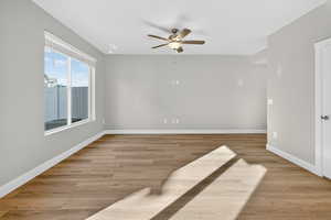 Unfurnished room featuring light wood-type flooring and a ceiling fan