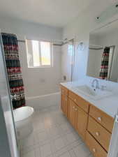 Bathroom featuring vanity and shower / bath combo with shower curtain