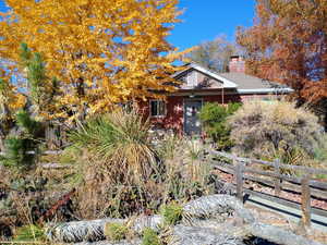 View of front of home with brick siding and a chimney