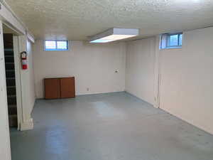 Basement with healthy amount of natural light and a textured ceiling