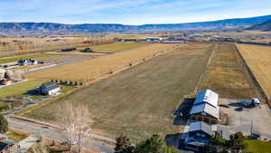 Aerial view of sparsely populated area featuring a mountainous background and farmland