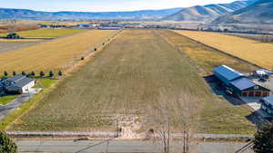 Aerial view of sparsely populated area with mountains and farmland