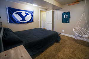 Bedroom featuring carpet flooring and baseboards