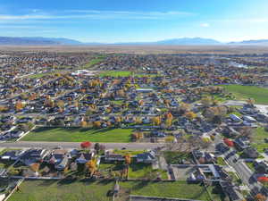 Aerial view of property's location with nearby suburban area and mountains