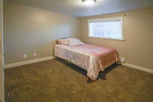 Bedroom with carpet and a textured ceiling