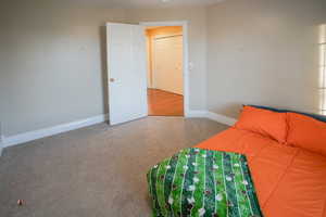 Bedroom featuring carpet floors and baseboards