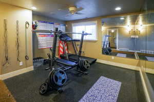 Workout room featuring rubber floors, a textured ceiling, a ceiling fan, and recessed lighting