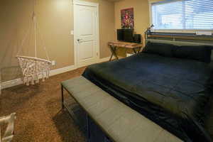 Bedroom with carpet floors and baseboards
