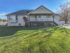 View of front of house with a patio, ceiling fan, and stairs