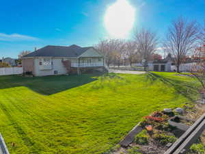 Rear view of house with a balcony, brick siding, and an outdoor structure