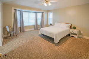 Bedroom with light carpet and ceiling fan