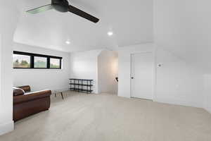 Living area featuring light carpet, an upstairs landing, recessed lighting, and ceiling fan
