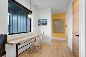 Home office with light wood-type flooring