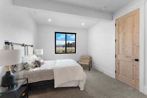 Carpeted bedroom with beam ceiling and recessed lighting