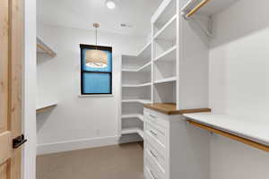 Spacious closet featuring light carpet