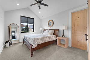 Bedroom with carpet, ceiling fan, and high vaulted ceiling