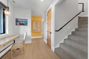 Office featuring light wood-style floors, a baseboard heating unit, and recessed lighting