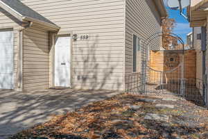 Property entrance featuring a garage and roof with shingles