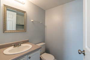 Bathroom with a textured ceiling and vanity