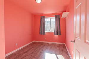 Unfurnished room featuring wood finished floors and baseboards