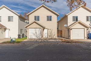Traditional-style home with asphalt driveway and a garage