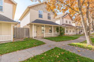 Traditional-style home with a porch and a shingled roof