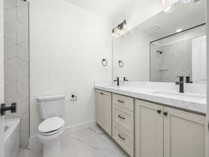 Full bathroom featuring double vanity, light marble finish floors, and shower / bath combination