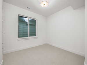 Empty room with carpet flooring and baseboards