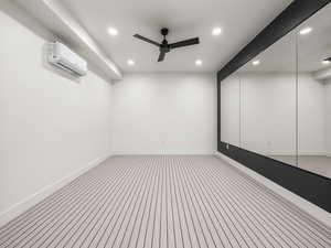 Spare room with recessed lighting, a ceiling fan, and a wall mounted AC