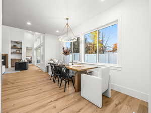 Dining space with recessed lighting and light wood-style floors